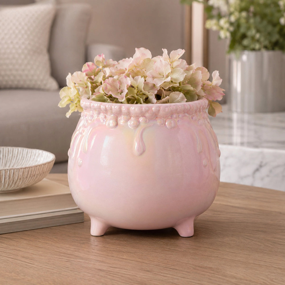 Light pink iridescent cauldron bowl with raised bubble-and-drip detailing around the rim.